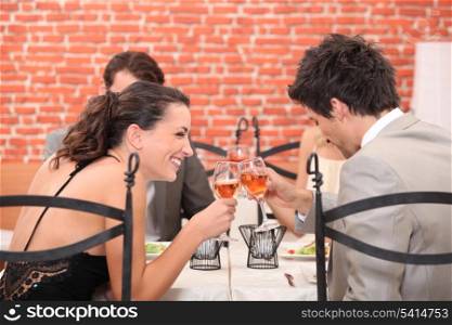 happy couple drinking wine in a restaurant