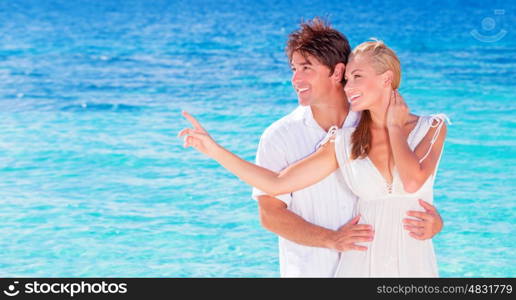 Happy couple enjoying beach, young family in love spending honeymoon vacation on luxury islands, cheerful active young people having fun at summertime travels, joy of life concept