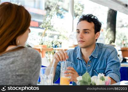 Happy couple enjoying breakfast in a cafe. Love and lifestyle concept.