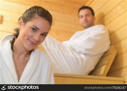 happy couple enjoying the sauna together at the spa