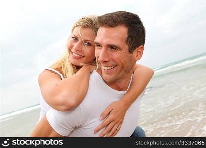 Happy couple enjoying vacation on a sandy beach