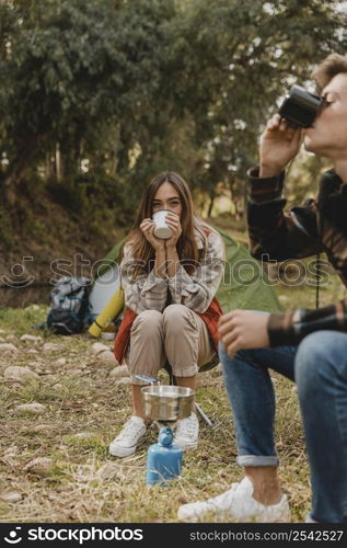 happy couple forest drinking from mugs