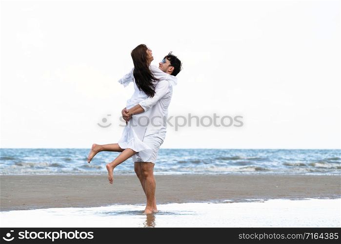Happy couple going honeymoon travel on tropical sand beach in summer.. Couple going honeymoon on tropical beach in summer