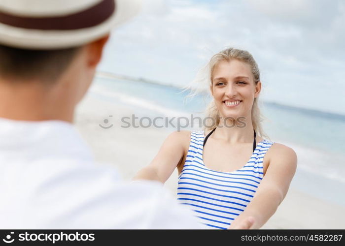 Happy couple having fun on the beach.. Happy young couple having fun on the beach.