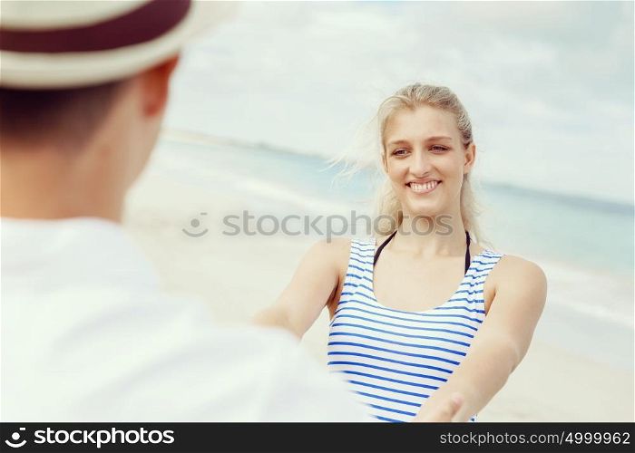 Happy couple having fun on the beach.. Happy young couple having fun on the beach.