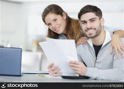 happy couple holding some paper work
