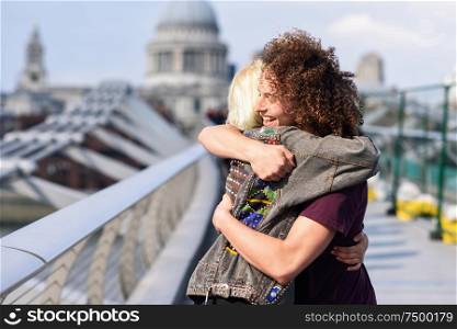 Happy couple hugging by Millennium bridge, River Thames, London. UK. Happy couple hugging by Millennium bridge, River Thames, London.
