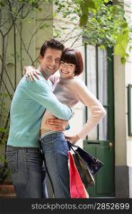 Happy Couple Hugging on Sidewalk