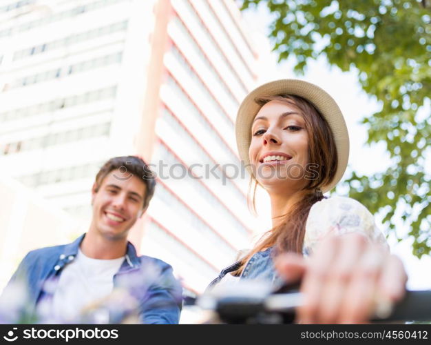 Happy couple in city with bike. Happy young couple in city with bike