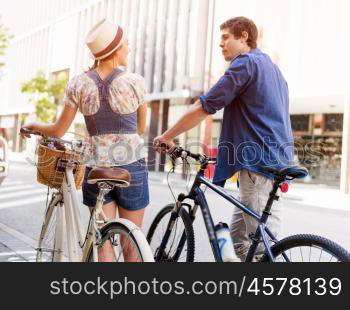 Happy couple in city with bike. Happy young couple in city with bike