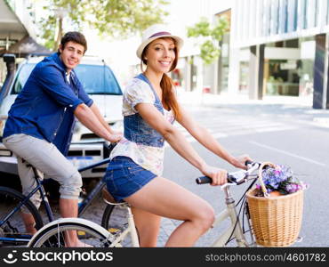 Happy couple in city with bike. Happy young couple in city with bike