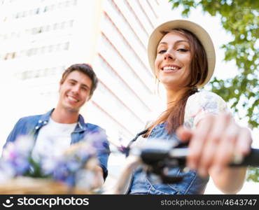 Happy couple in city with bike. Happy young couple in city with bike