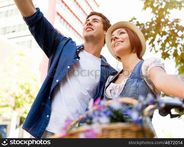 Happy couple in city with bike. Happy young couple in city with bike