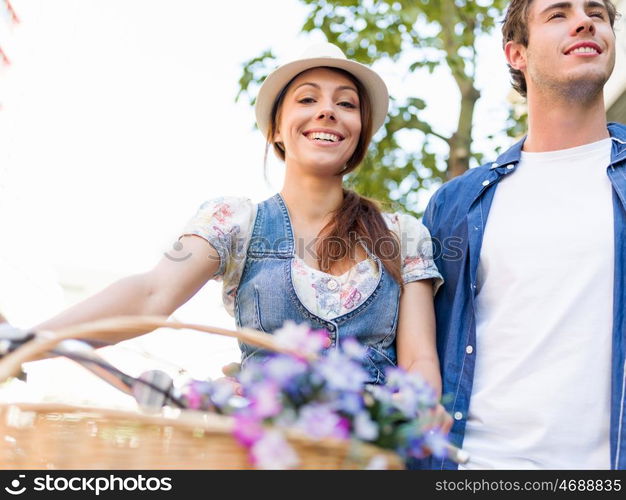 Happy couple in city with bike. Happy young couple in city with bike