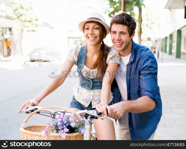 Happy couple in city with bike. Happy young couple in city with bike