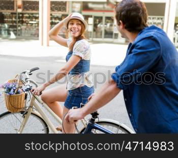 Happy couple in city with bike. Happy young couple in city with bike