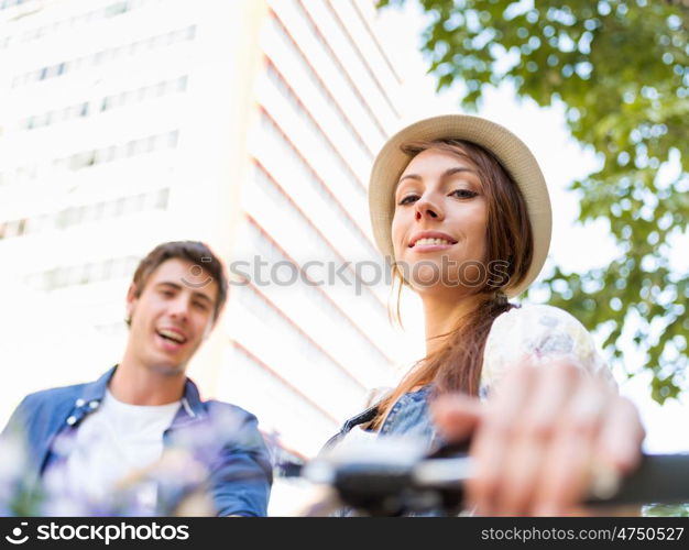 Happy couple in city with bike. Happy young couple in city with bike