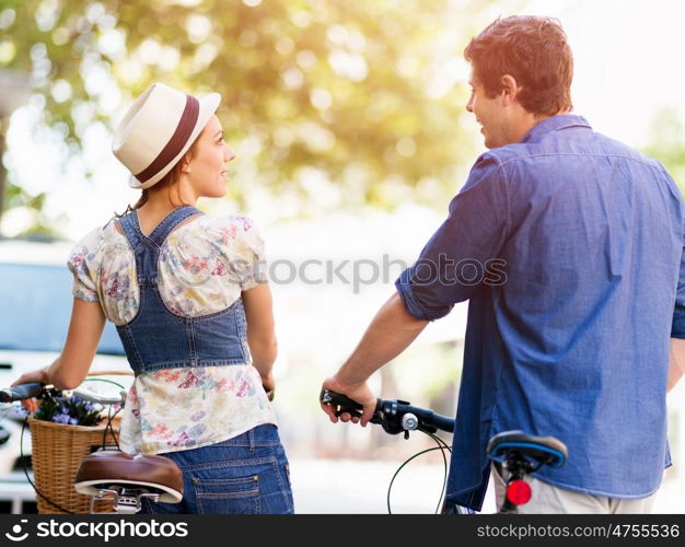 Happy couple in city with bike. Happy young couple in city with bike