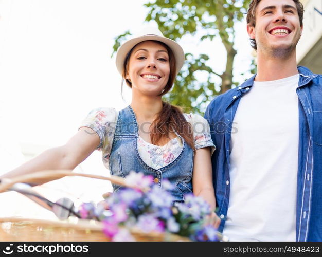 Happy couple in city with bike. Happy young couple in city with bike