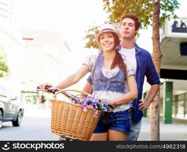 Happy couple in city with bike. Happy young couple in city with bike