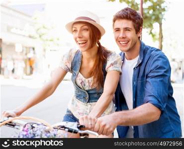 Happy couple in city with bike. Happy young couple in city with bike