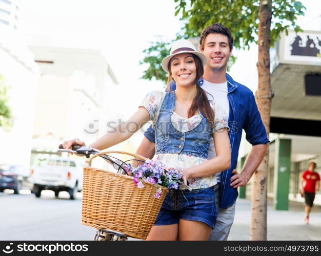 Happy couple in city with bike. Happy young couple in city with bike