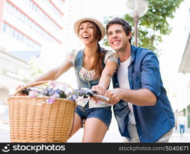 Happy couple in city with bike. Happy young couple in city with bike