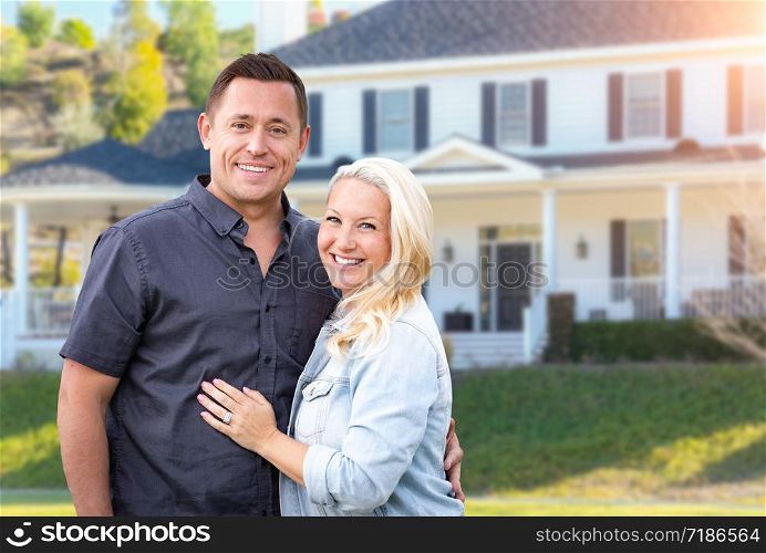 Happy Couple In Front of Beautiful House.