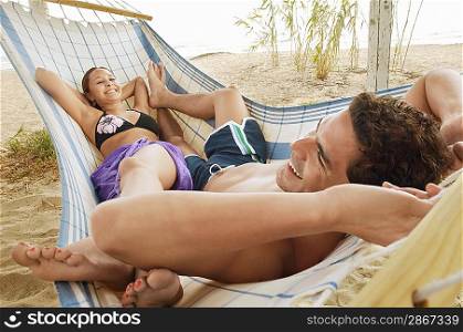Happy Couple in Hammock on Beach