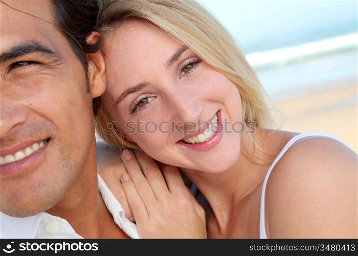 Happy couple in holidays at the beach