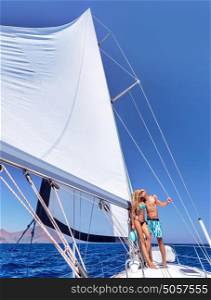 Happy couple in honeymoon vacation in luxury sea cruise, enjoying each other and travel on beautiful sailboat