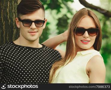 Happy couple in park. Love and happiness. Young happy couple lovers wearing sunglasses dating in summer park outdoor.
