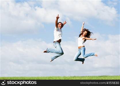 Happy couple jumping high of joy