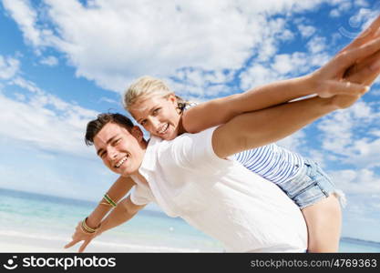 Happy couple jumping on beach vacations. Travel concept of young couple cheering for summer holidays on beach