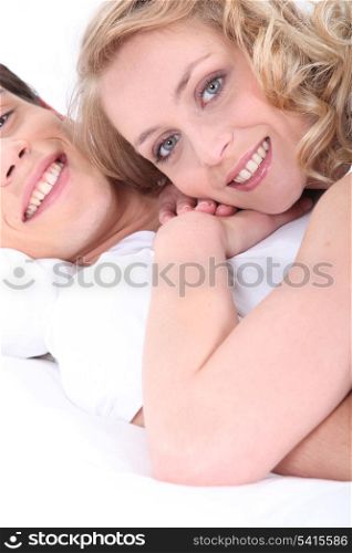 Happy couple laying in bed