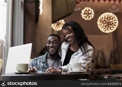 happy couple looking laptop