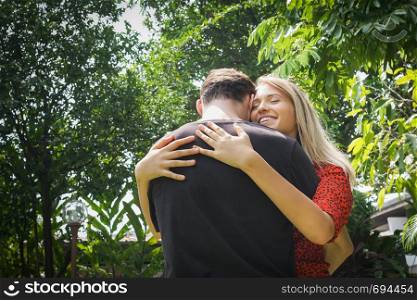 Happy couple love and hug together in nature outdoor