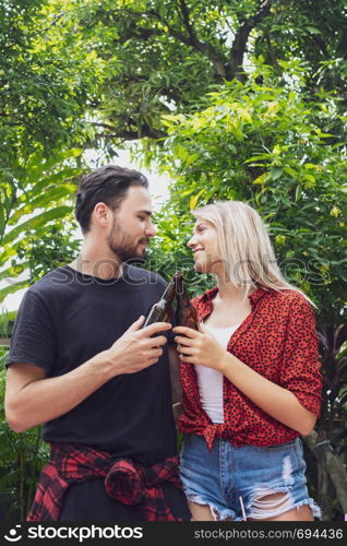 Happy couple love toasting beer for camping in nature outdoor as summer lifestyle