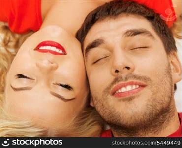happy couple lying at home with closed eyes (focus on woman)