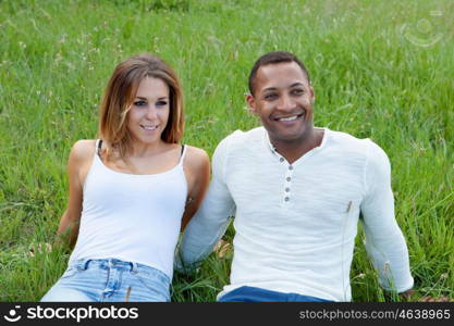 Happy couple lying on the grass in the field thinking about his future