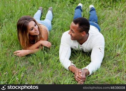 Happy couple lying on the grass in the field thinking about his future