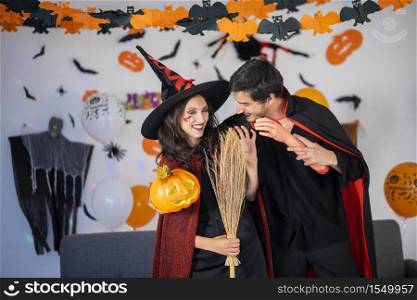 happy couple of love in costumes and makeup on a celebration of Halloween