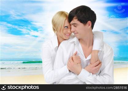 Happy couple on the sunny tropical beach