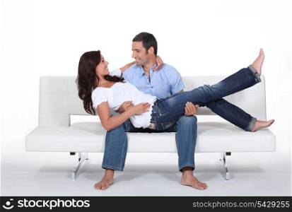 Happy couple on white sofa