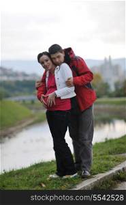 happy couple outdoor, beautiful pregnant woman with her husband
