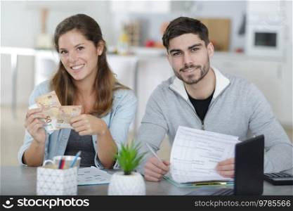 happy couple planning family budget