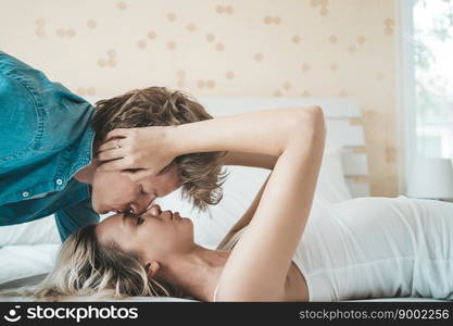 Happy Couple Playing together in the bedroom