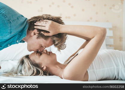 Happy Couple Playing together in the bedroom