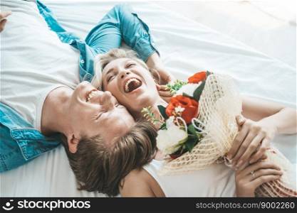 Happy Couple Playing together in the bedroom