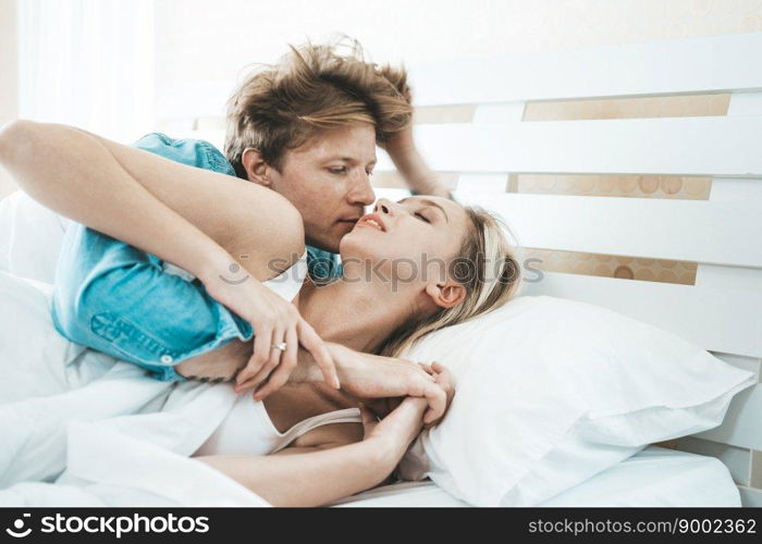 Happy Couple Playing together in the bedroom